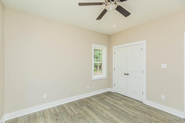 unfurnished bedroom featuring a closet, ceiling fan, and light hardwood / wood-style flooring