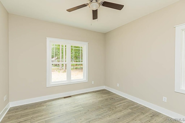 empty room featuring ceiling fan and light wood-type flooring