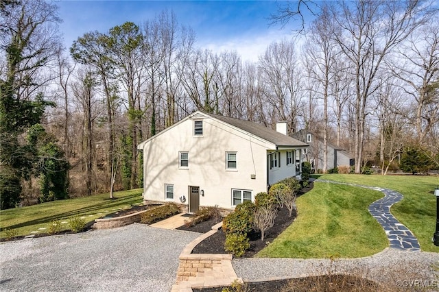 view of side of home featuring a lawn