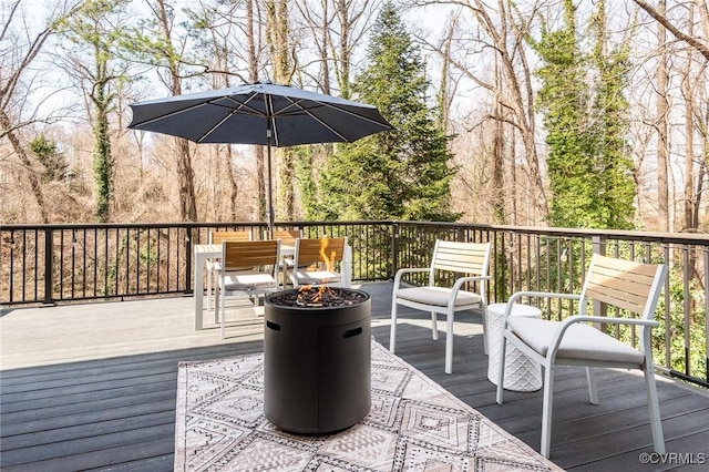 wooden terrace with an outdoor fire pit