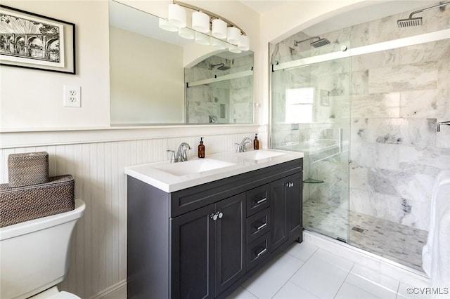 bathroom with vanity, toilet, and a shower with shower door