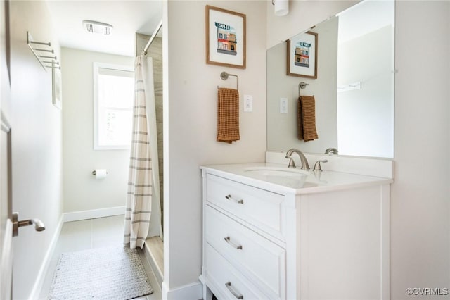 bathroom featuring a shower with shower curtain, vanity, and tile patterned flooring