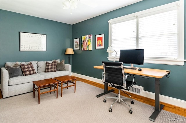 home office featuring a wealth of natural light and hardwood / wood-style floors