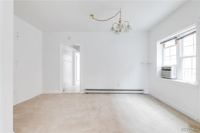 carpeted empty room featuring an inviting chandelier and baseboard heating