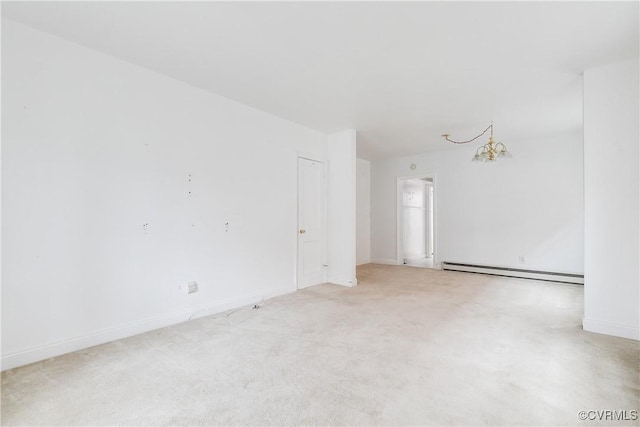 carpeted empty room with a chandelier and baseboard heating