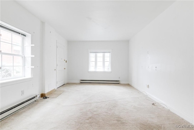 carpeted empty room with a baseboard heating unit