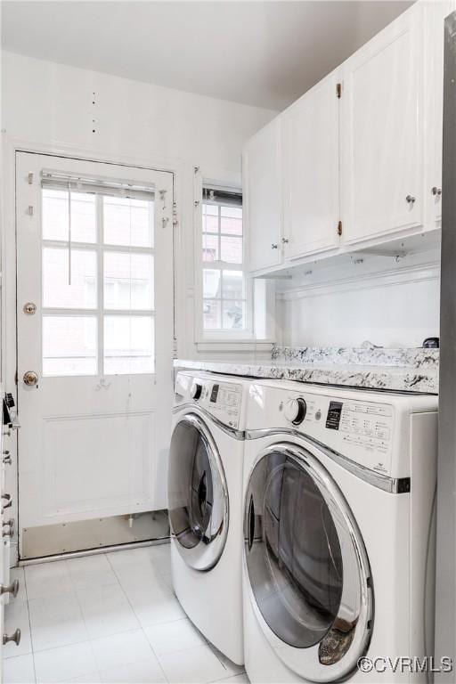 washroom featuring independent washer and dryer and cabinets