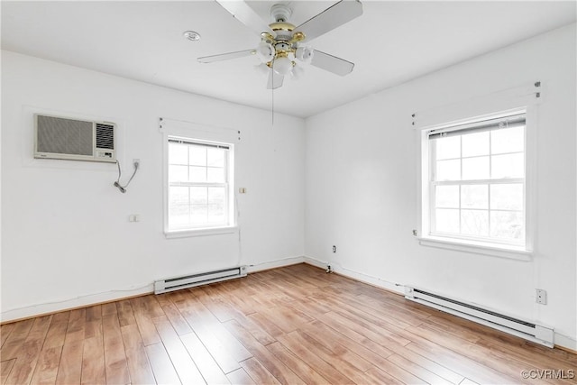 unfurnished room with a wealth of natural light, a baseboard radiator, and light wood-type flooring