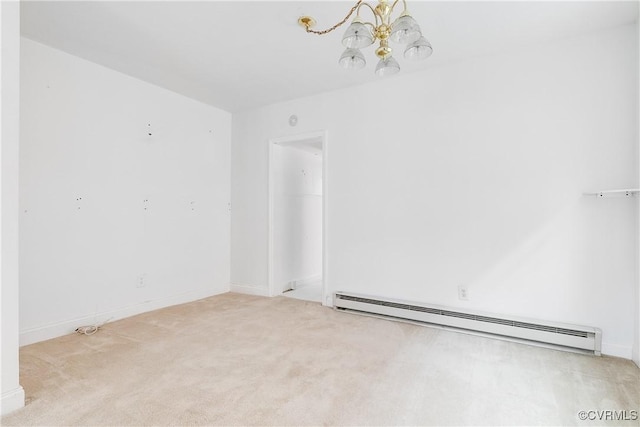 carpeted empty room with a baseboard radiator and an inviting chandelier