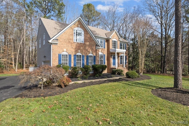 view of front of property with a front yard and a garage