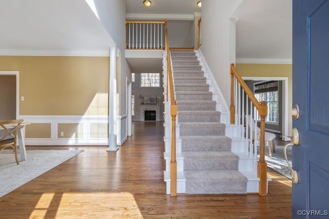 entryway featuring hardwood / wood-style floors, plenty of natural light, and ornamental molding