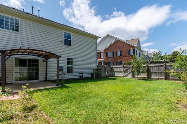 rear view of property featuring a yard, a pergola, and a patio area