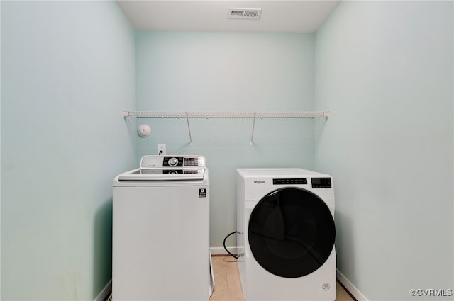 clothes washing area with washer and dryer