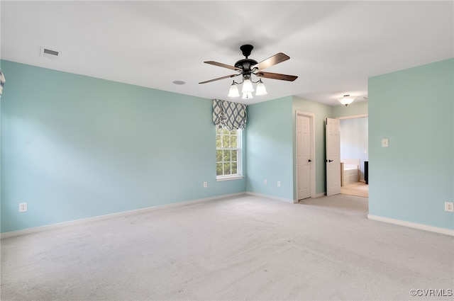 carpeted spare room featuring ceiling fan