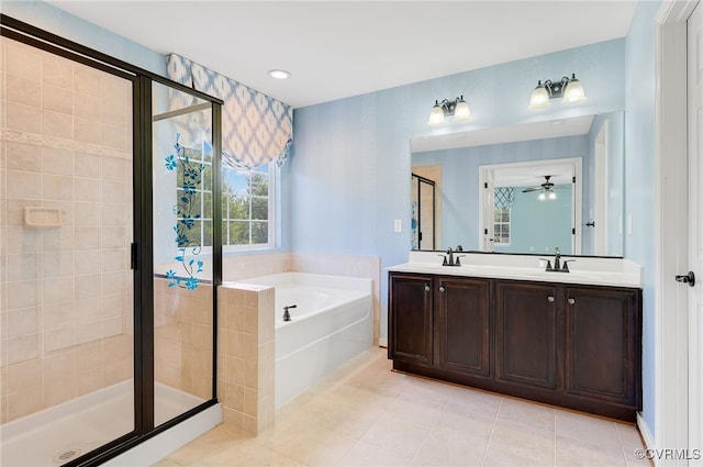 bathroom featuring tile patterned floors, vanity, and shower with separate bathtub