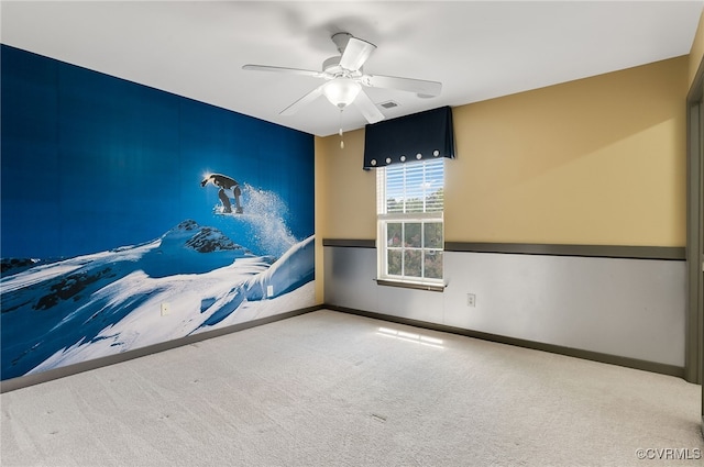 unfurnished room featuring ceiling fan and light carpet