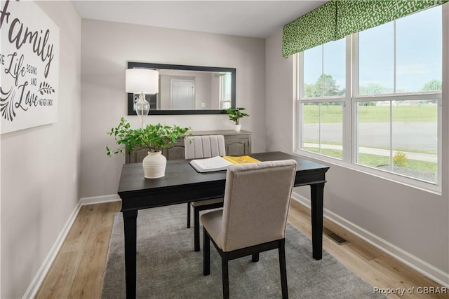 home office with radiator and light hardwood / wood-style flooring