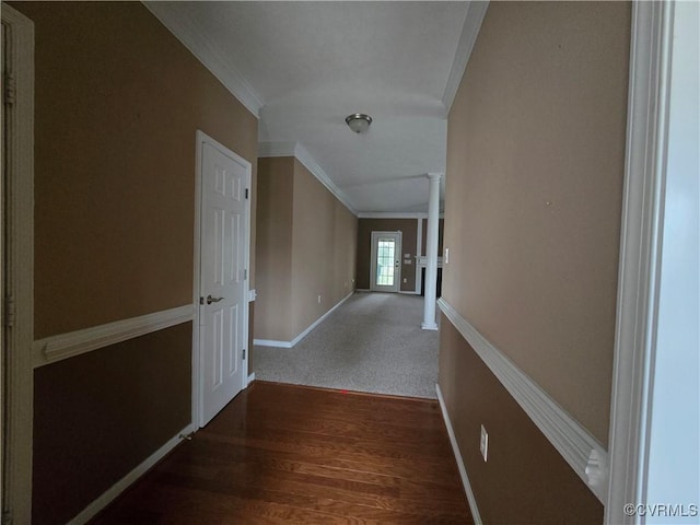 corridor with ornate columns, ornamental molding, and dark hardwood / wood-style floors