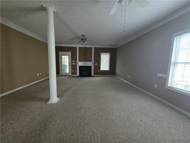 unfurnished living room featuring crown molding and decorative columns