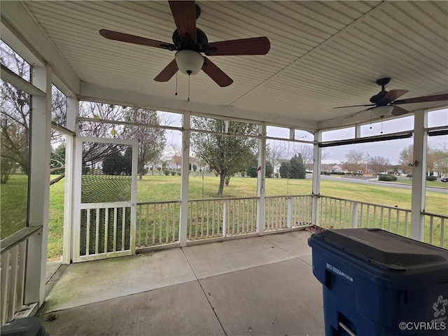 unfurnished sunroom with a wealth of natural light and ceiling fan