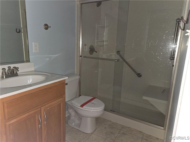 bathroom with an enclosed shower, vanity, tile patterned flooring, and toilet