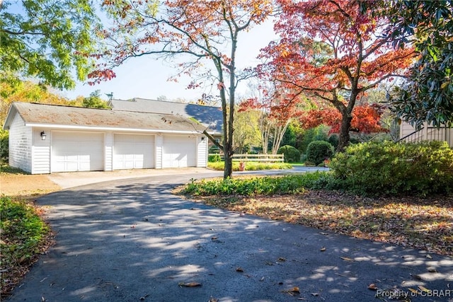 exterior space featuring a garage and an outdoor structure