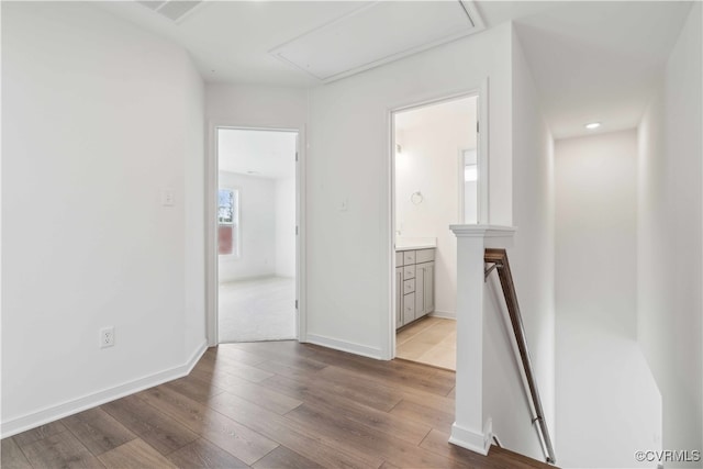 hallway with light hardwood / wood-style floors