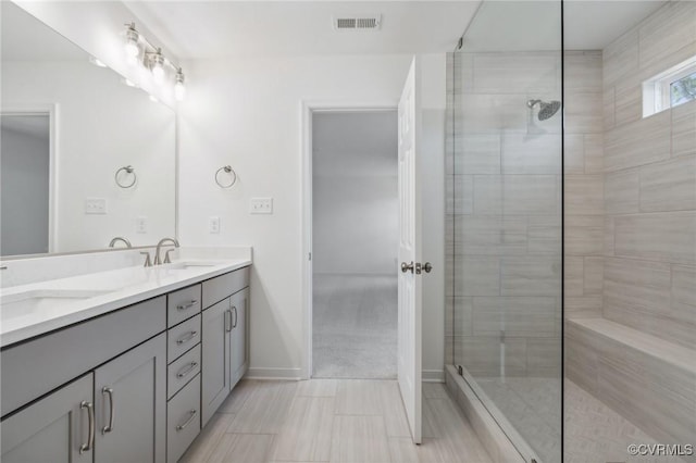 bathroom featuring vanity and tiled shower