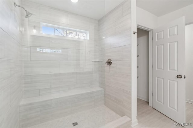 bathroom with tiled shower