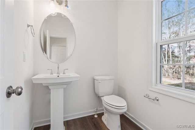 bathroom with hardwood / wood-style floors and toilet