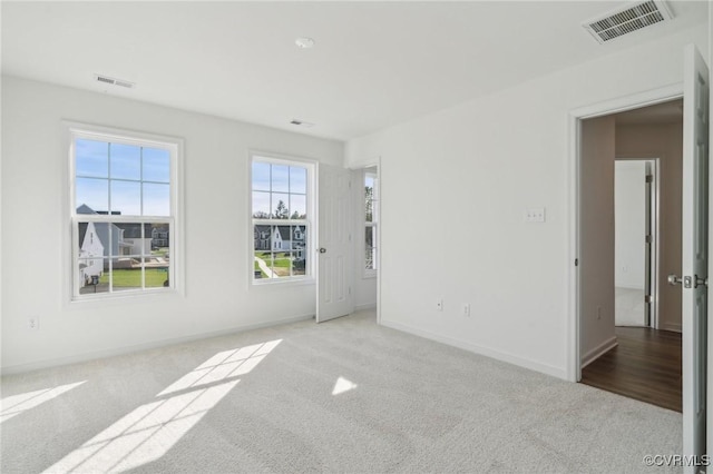 unfurnished room with light colored carpet