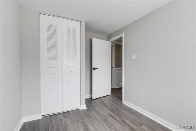 unfurnished bedroom with light hardwood / wood-style flooring and a closet