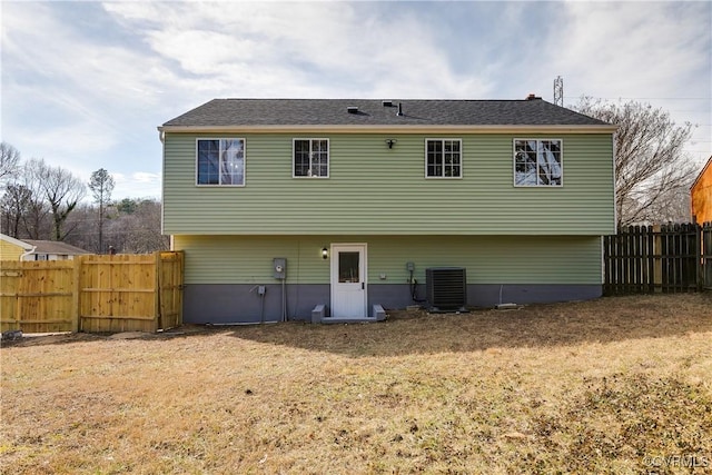 back of house with a yard and central AC unit