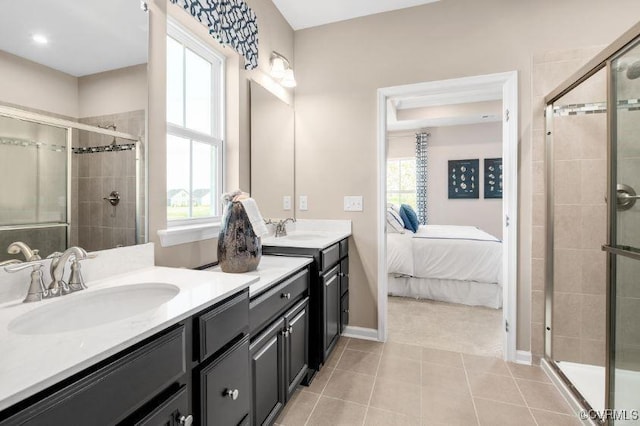 bathroom with tile patterned flooring, vanity, a healthy amount of sunlight, and an enclosed shower