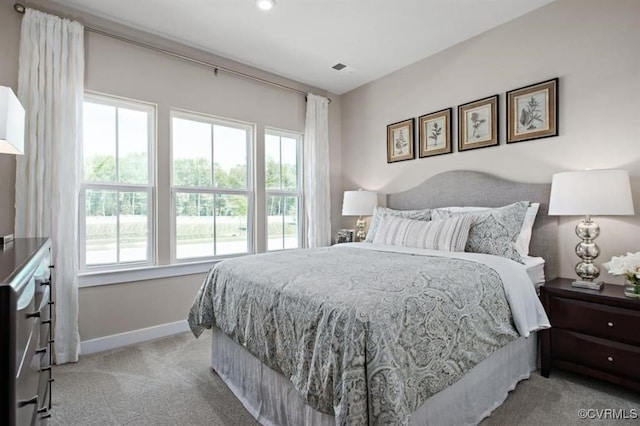 bedroom featuring light colored carpet