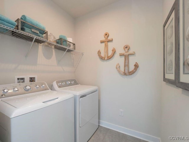 laundry room with washer and dryer and light tile patterned floors