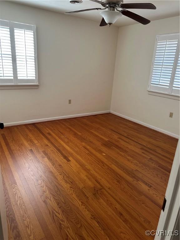 unfurnished room featuring hardwood / wood-style floors and ceiling fan