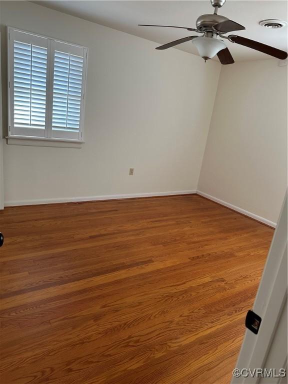 empty room featuring hardwood / wood-style floors and ceiling fan