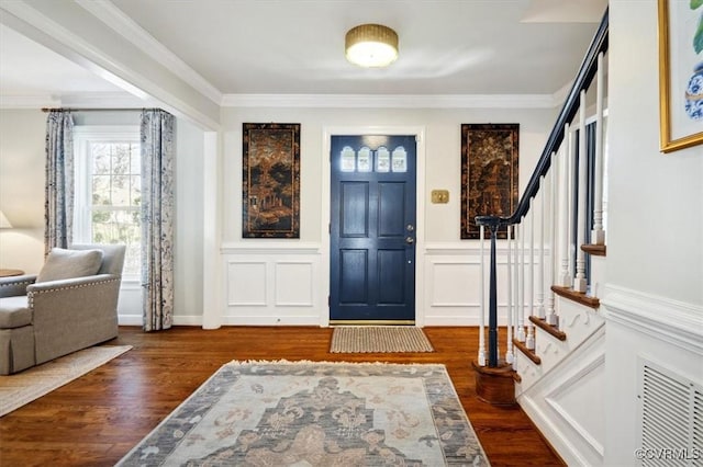 entryway featuring crown molding and dark hardwood / wood-style floors