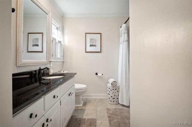 bathroom with toilet, vanity, and crown molding