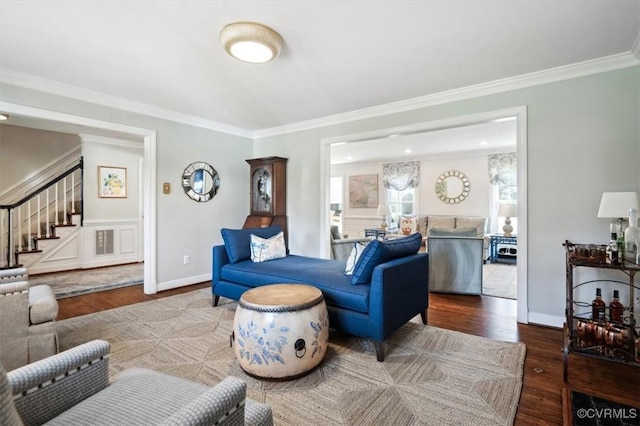 living room with hardwood / wood-style flooring and ornamental molding