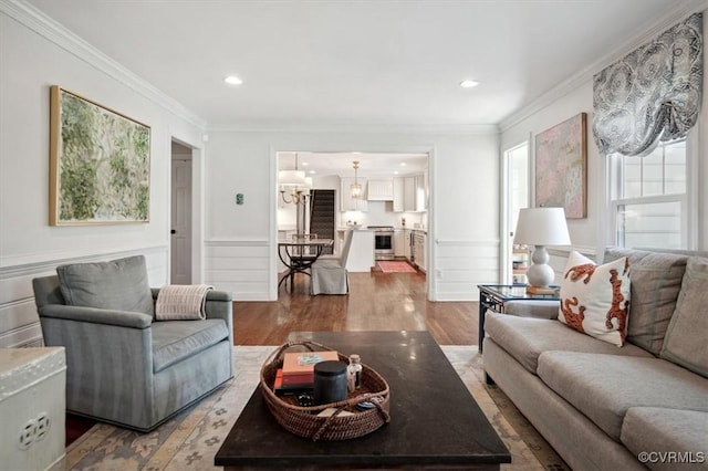 living room with hardwood / wood-style floors and ornamental molding