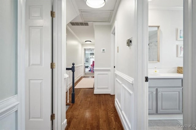 corridor featuring crown molding and dark hardwood / wood-style flooring