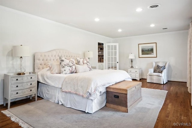 bedroom featuring crown molding and dark hardwood / wood-style floors