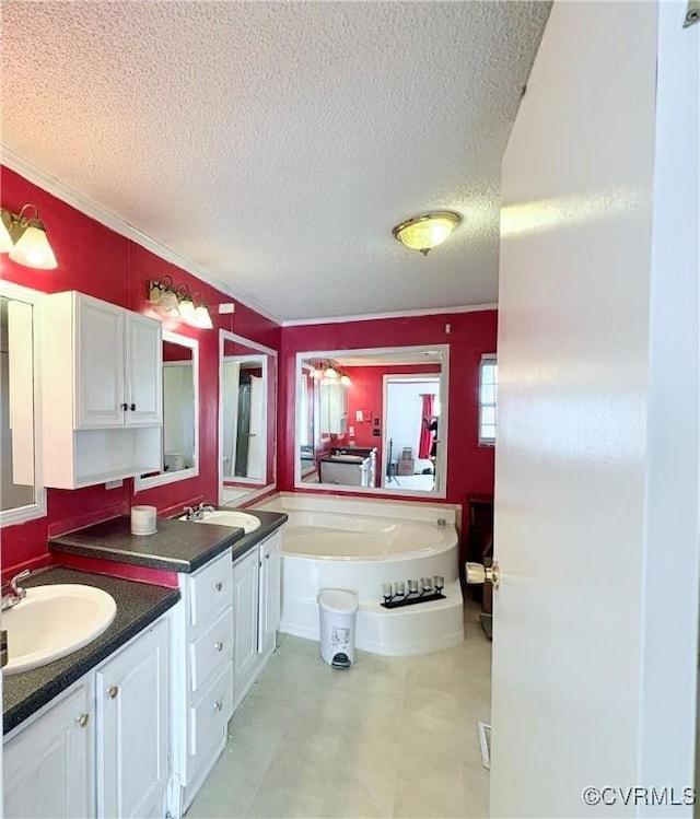 bathroom with vanity, a bath, crown molding, and a textured ceiling