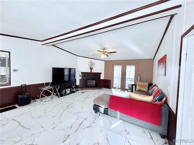 living room featuring ceiling fan and a textured ceiling