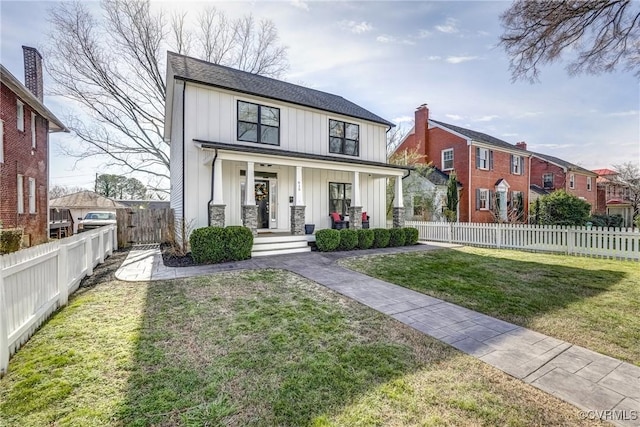 view of front of house with a porch and a front lawn