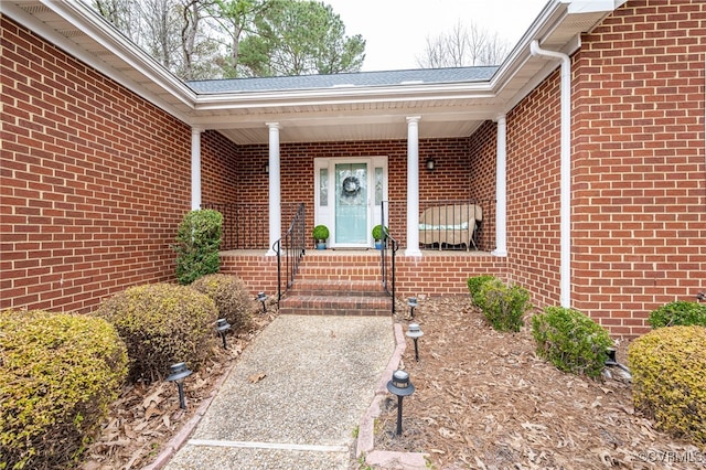 view of exterior entry featuring covered porch