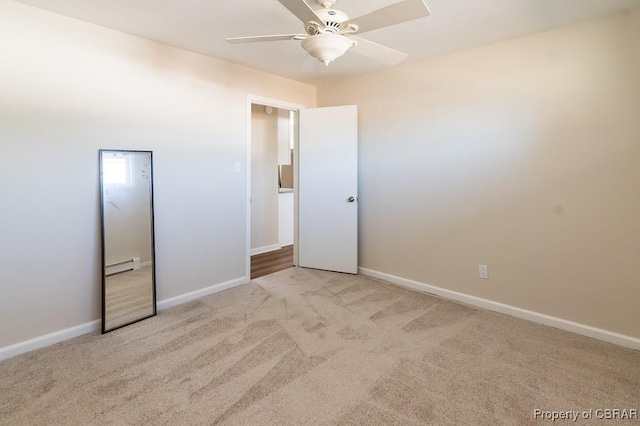 unfurnished bedroom featuring ceiling fan, light colored carpet, and a baseboard heating unit