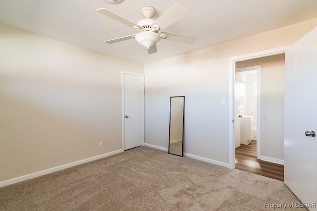 unfurnished bedroom featuring ceiling fan and carpet